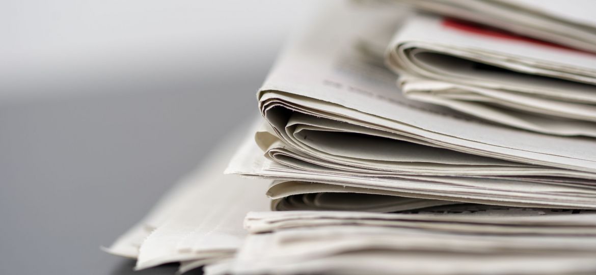 Closeup shot of several newspapers stacked on top of each other
