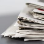 A closeup shot of several newspapers stacked on top of each other