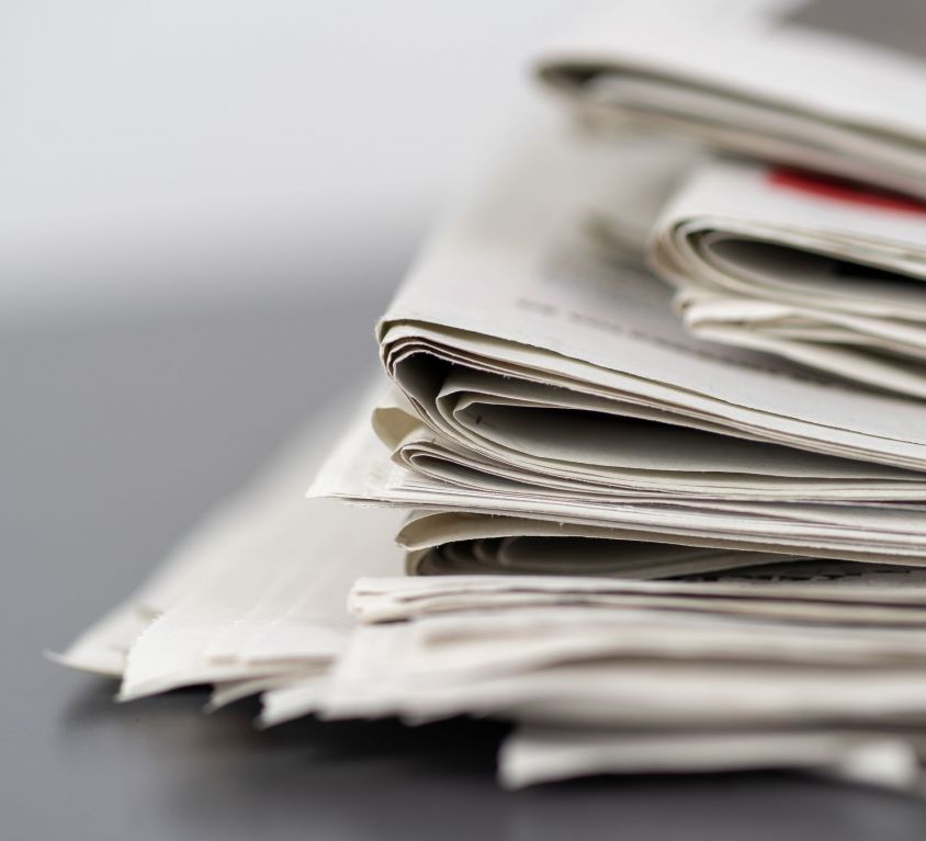 Closeup shot of several newspapers stacked on top of each other